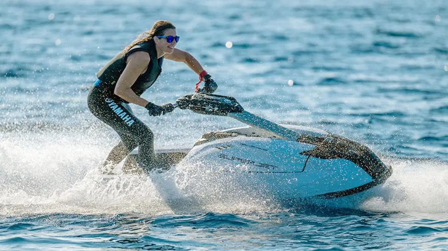 A woman racing over the water with her motorized superyacht toy