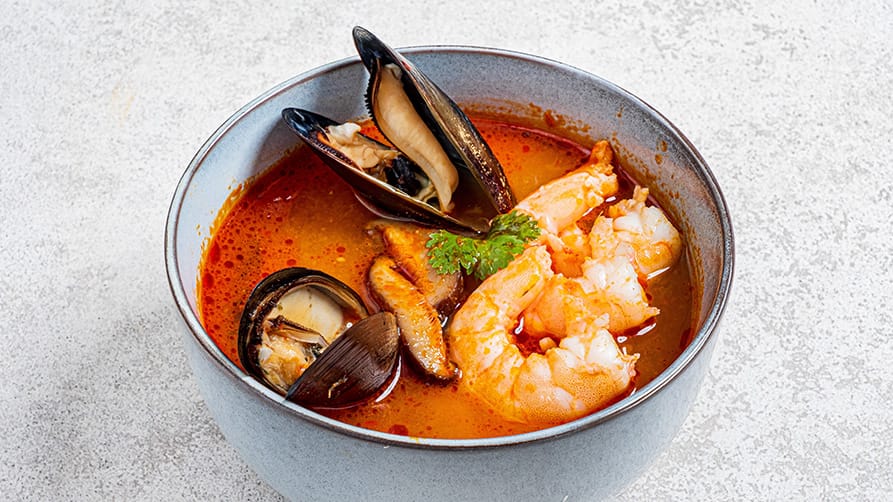 A bowl of gourmet bouillabaisse, a classic dish in French Riviera cuisine.