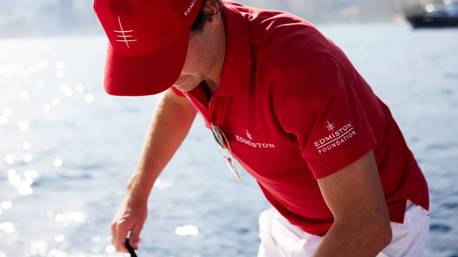 An Edmiston staff member providing a VIP experience at the Cannes Boat Show, showcasing luxury yachts and exclusive services.