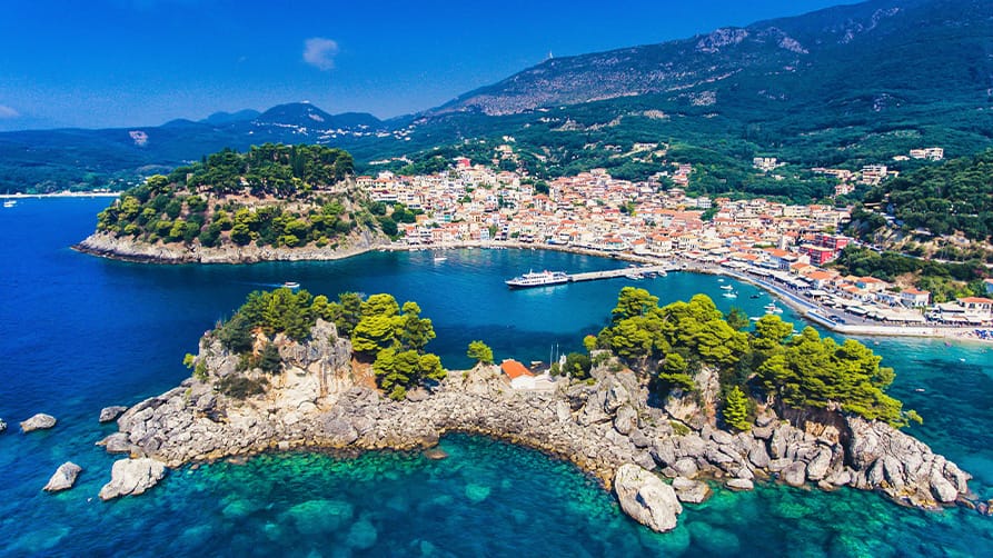 Aerial view of a coastal Mediterranean town, and marina, ideal for mooring whilst on your French Riviera yacht charter.