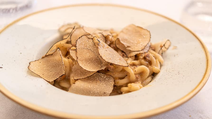 A bowl of truffle pasta, a staple of gourmet French Riviera cuisine, is served aboard a luxury French Riviera yacht charter.