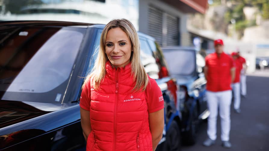 Edmiston VIP chauffeurs stand beside their Range Rovers at the 2024 Monaco Yacht Show.