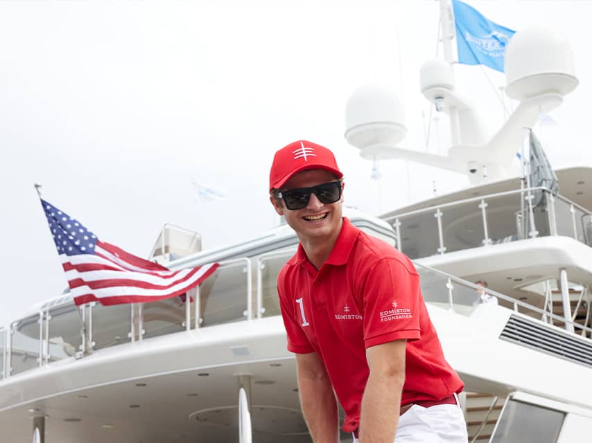 An Edmiston crew member ready to welcome visitors to the Fort Lauderdale International Boat Show 2024, showcasing luxury yachts and marine innovation.