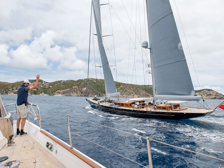 Man waving from a yacht in the st barths bucket race