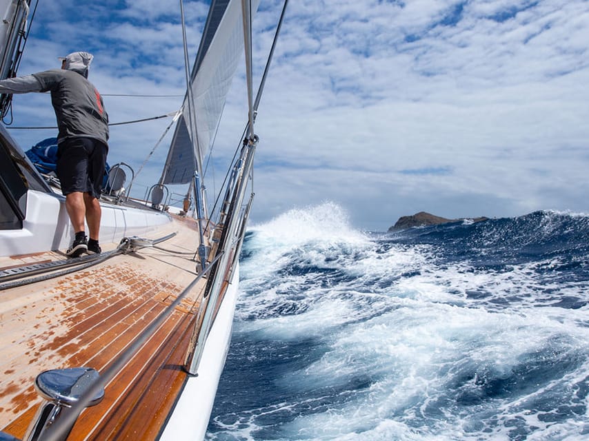 Man on a yacht navigating waves in the st barths bucket race